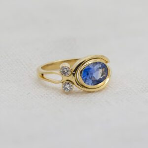 Bespoke tideline ring in gold diamonds and sapphire