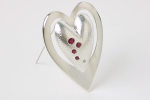brooch in silver set with rubies and diamond brooch in silver set with rubies and diamond