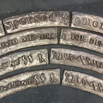 . Image of work in progress featuring a series of bronze plaques being prepared for patination. Image: artists own.