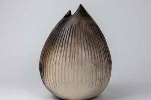Pod. Smoke-fired, carved ceramic vessel