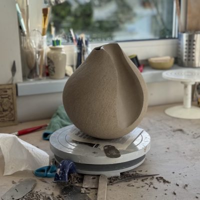 This is my work bench showing a selection of the simple tools that help me model the clay. Here I am at the refining stage where I work on the leather hard clay to finalise the build.