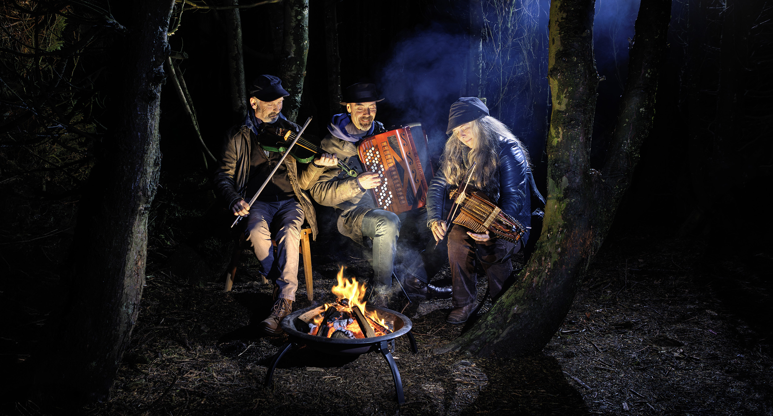 Musicians, "Firelight Trio" in the woods at night